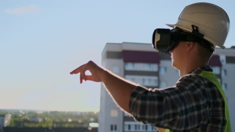 Builder-working-with-VR-glasses.-Builder-projecting-with-VR-glasses-future-exterior-standing-at-the-construction-site